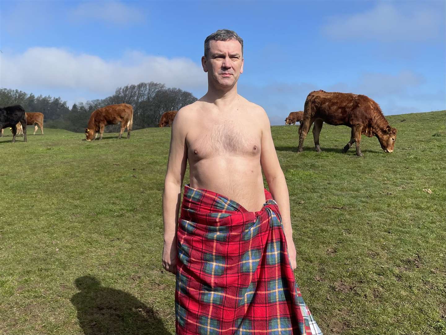 Graham Stewart poses with some cows (Ewan Pringle/PA)
