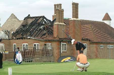 Players practice in front of the damaged club house. Picture: GARY BROWNE