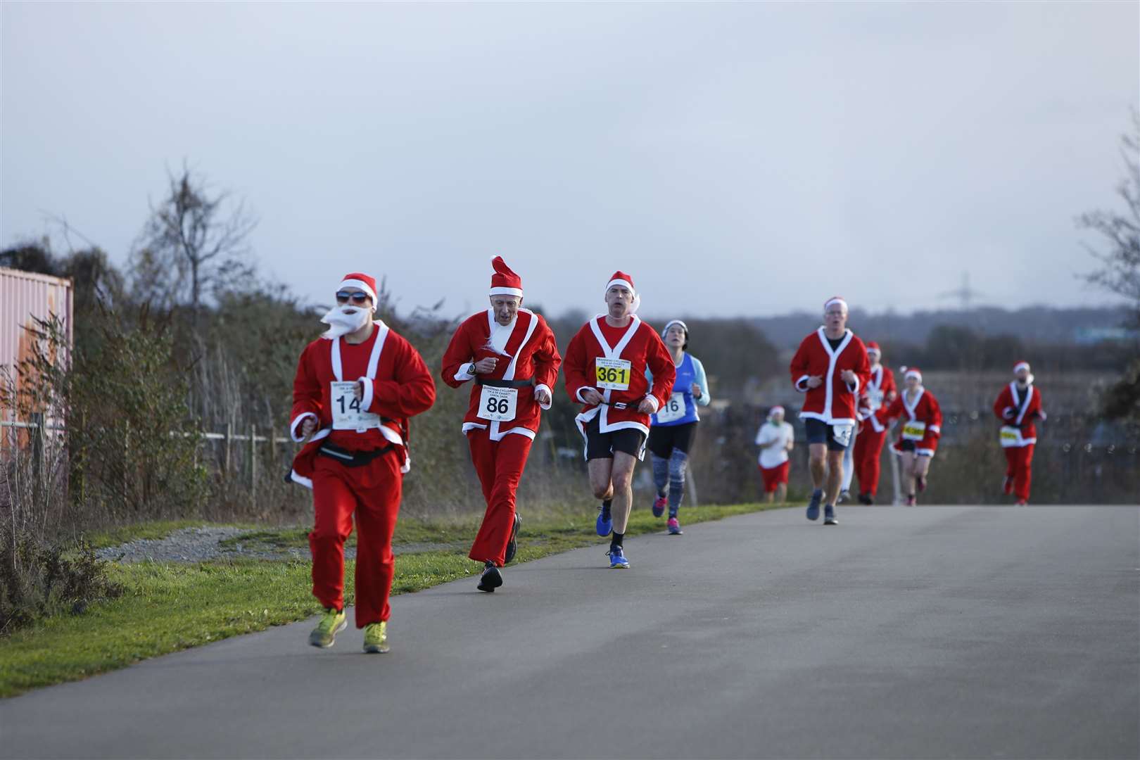 Santas dash to the finish line. Picture: Andy Jones. (24325608)