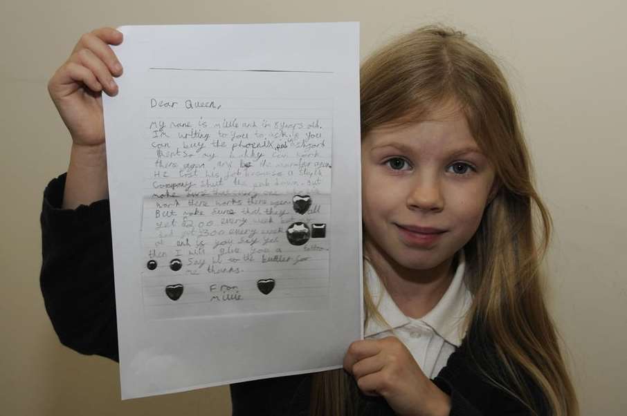 Eight year old Millie Oxenham with a copy of the letter she sent to The Queen