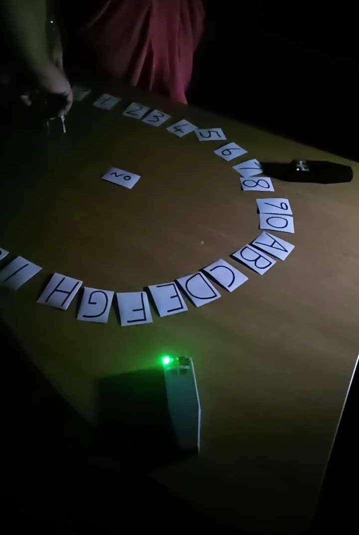 Sean uses a ouija board to communicate with spirits