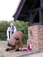 Andy Hyland, of G Hogben and Sons, lays a cross of poppies at the memorial