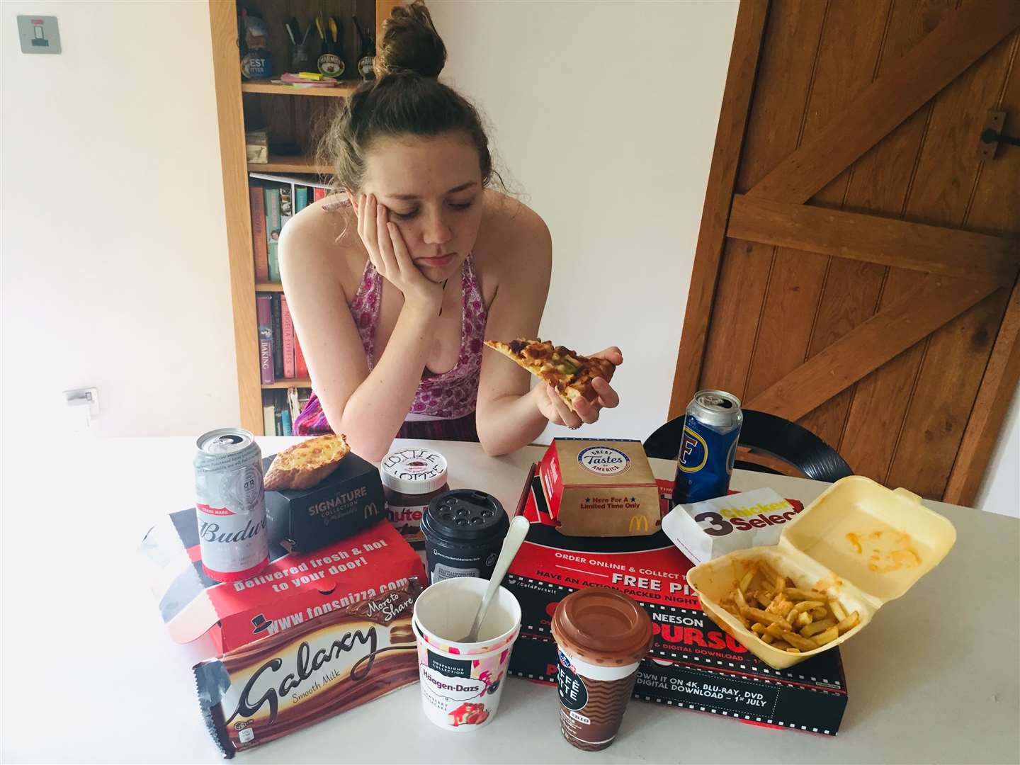 Rebecca surrounded by all the food she is going to try and resist for a week