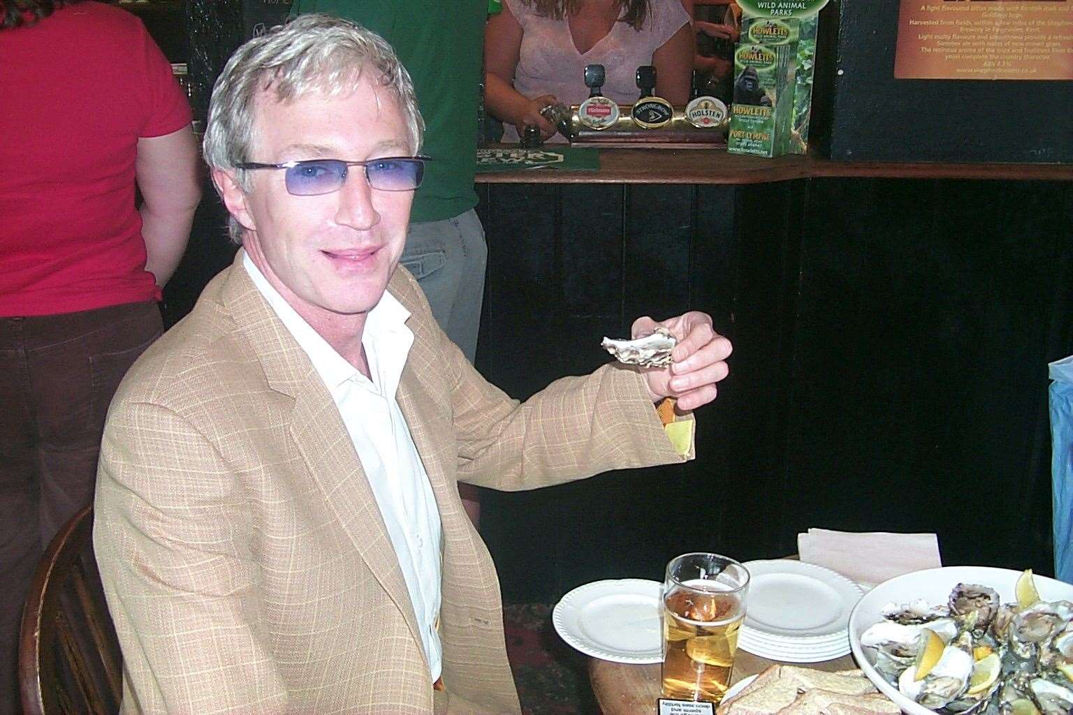 Paul O'Grady enjoys some oysters at the Walnut Tree pub after opening Aldington school fete