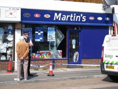 A policeman guards the Martin's store in Trafalgar Parade, The Broadway, Minster