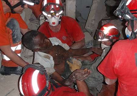 Kent firefighters help rescue a man from beneath rubble in Haiti capital Port-au-Prince.