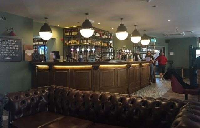There’s plenty of lighting around the bar and plenty of room on that large, leather sofa