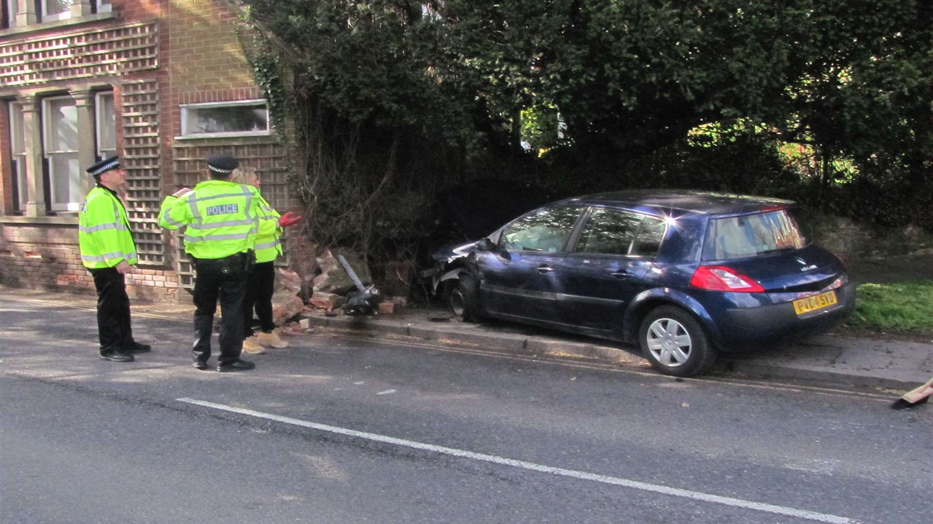 Policeman was driving car when it crashed into a house.