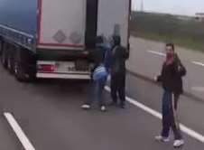 Illegal immigrants look for lorries to hide in at Calais