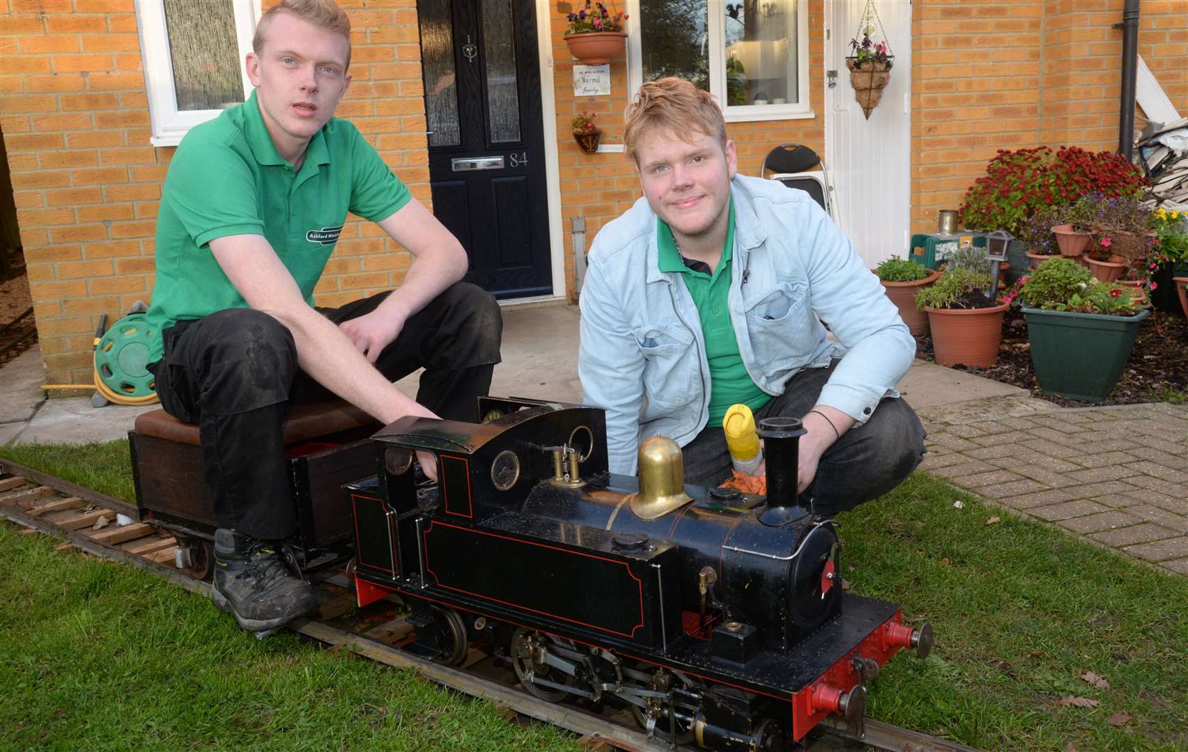 George and Oliver Stevens with the locomotive 'Bridget' on the miniature railway at their home in Ashford. Picture: Chris Davey