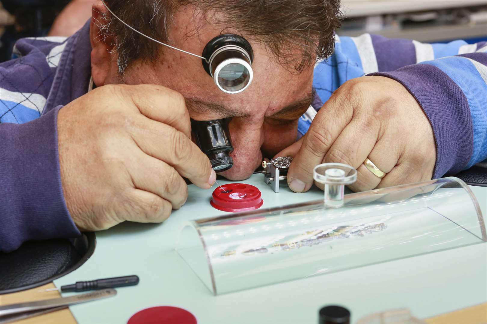 Senior watchmaker Marcos Cruz works on a timepiece at the company's service centre