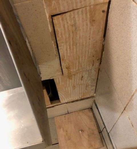The tiles on the right-hand side of the urinal had come away from the wall