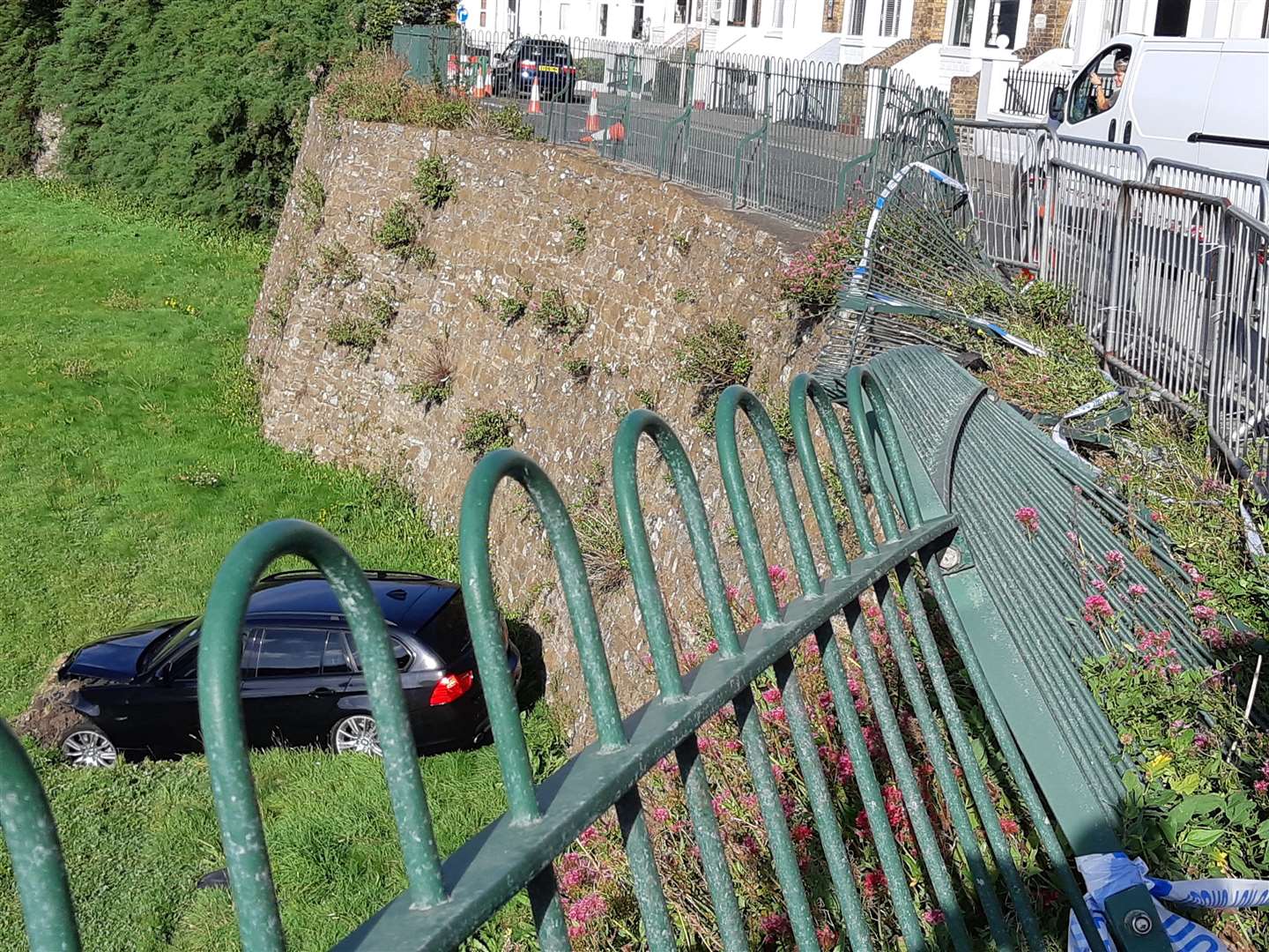 The car smashed through railings before landing in the moat