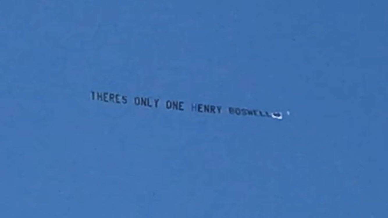A flypast bears a banner in Henry's honour