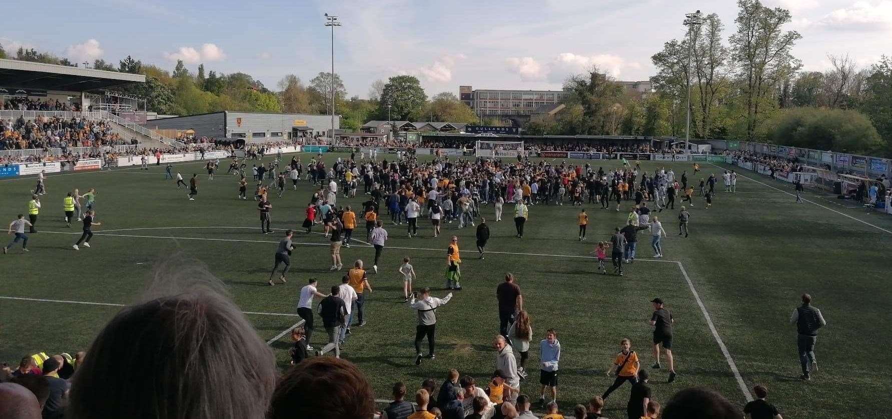 Maidstone fans rush on to the pitch to celebrate their promotion. Picture: Eddie Waddell (56384460)