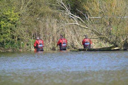 Officers search Mote Park lake this afternoon. Picture by Martin Apps