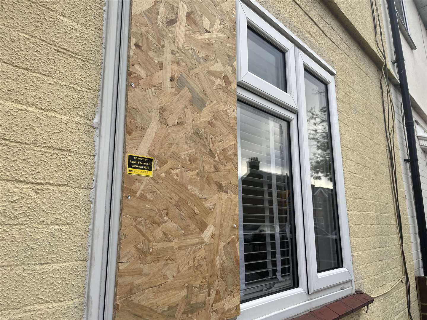 The window at the front of the house which was smashed has now been boarded up