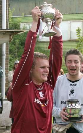 City skipper Dan Bonneywell lifts the Kent Junior Cup watched by keeper Danny Black
