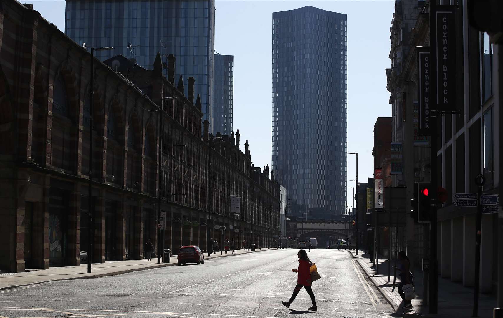 A woman walks down a deserted Deansgate in Manchester (Martin Rickett/PA)