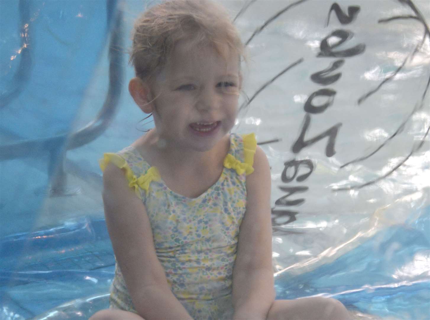 Josie Weed, 5, waits for the zorbing ball to fill with air