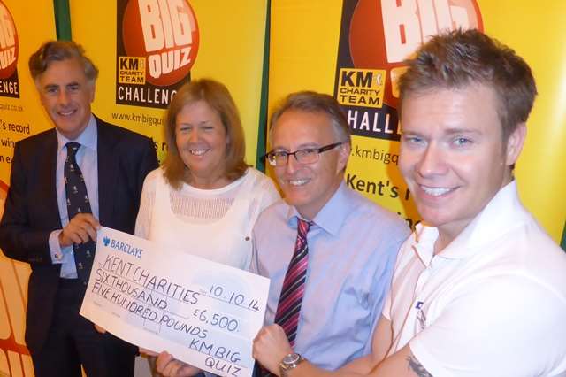 KM Big Quiz partners announce that £6.5k is raised for south Kent good causes at the 2014 Ashford Big Charity Quiz. Left to right: Richard Rix of Hallet and Co, Beverley Walsh of Barclays, Clive Perry of Specsavers and Gareth Harmer of PropertyOnline.