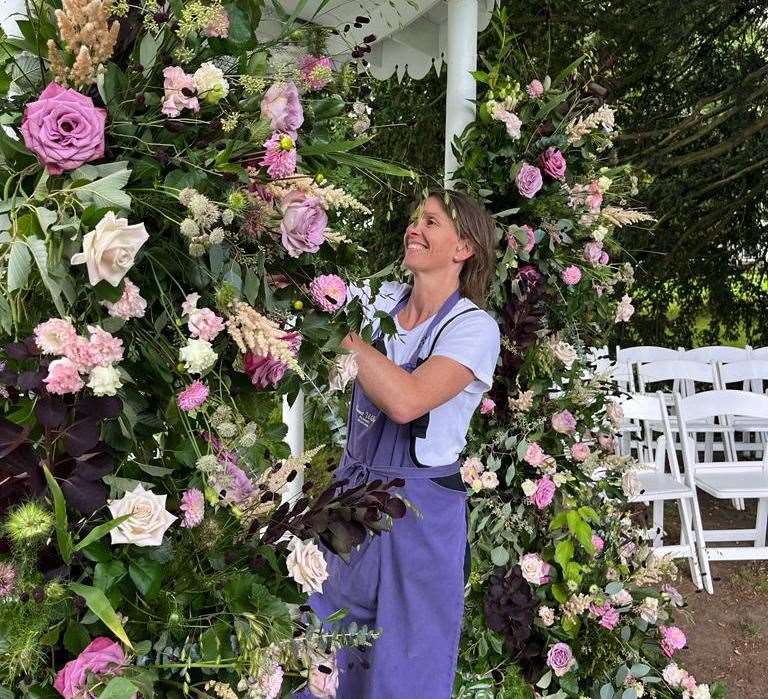 Julia arranging a floral decoration at a wedding in Preston Court, Canterbury. Picture: Julia Archer