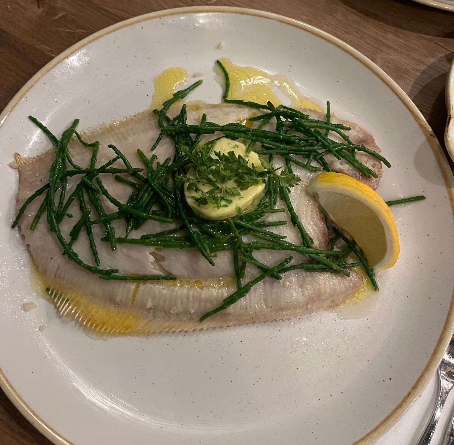 The whole grilled lemon sole served with seaweed butter, samphire and buttered Nichola potatoes