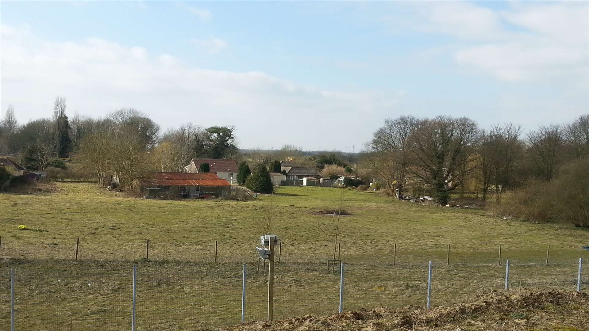 The site near Stop 24 on the M20 junction 11 where 60 new lorry spaces are going. They are within the boundary of the second fence. More spaces are planned for land behind the buildings shown.