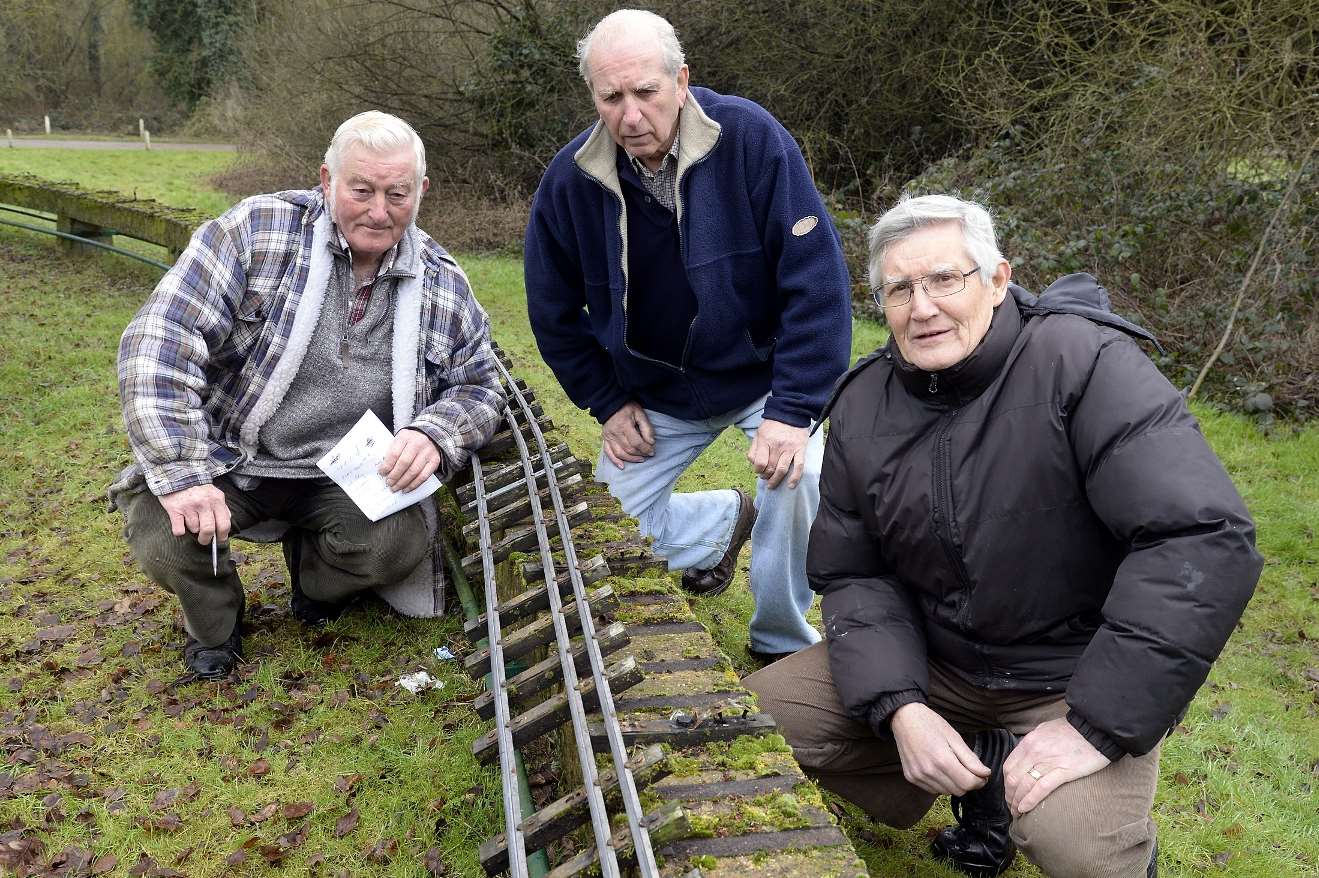 Members survey the damage to the track