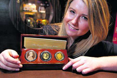 Christine Buss, from Scoin Shop, displays some of the Diamond Jubilee coins. Picture: Ally Carmichael
