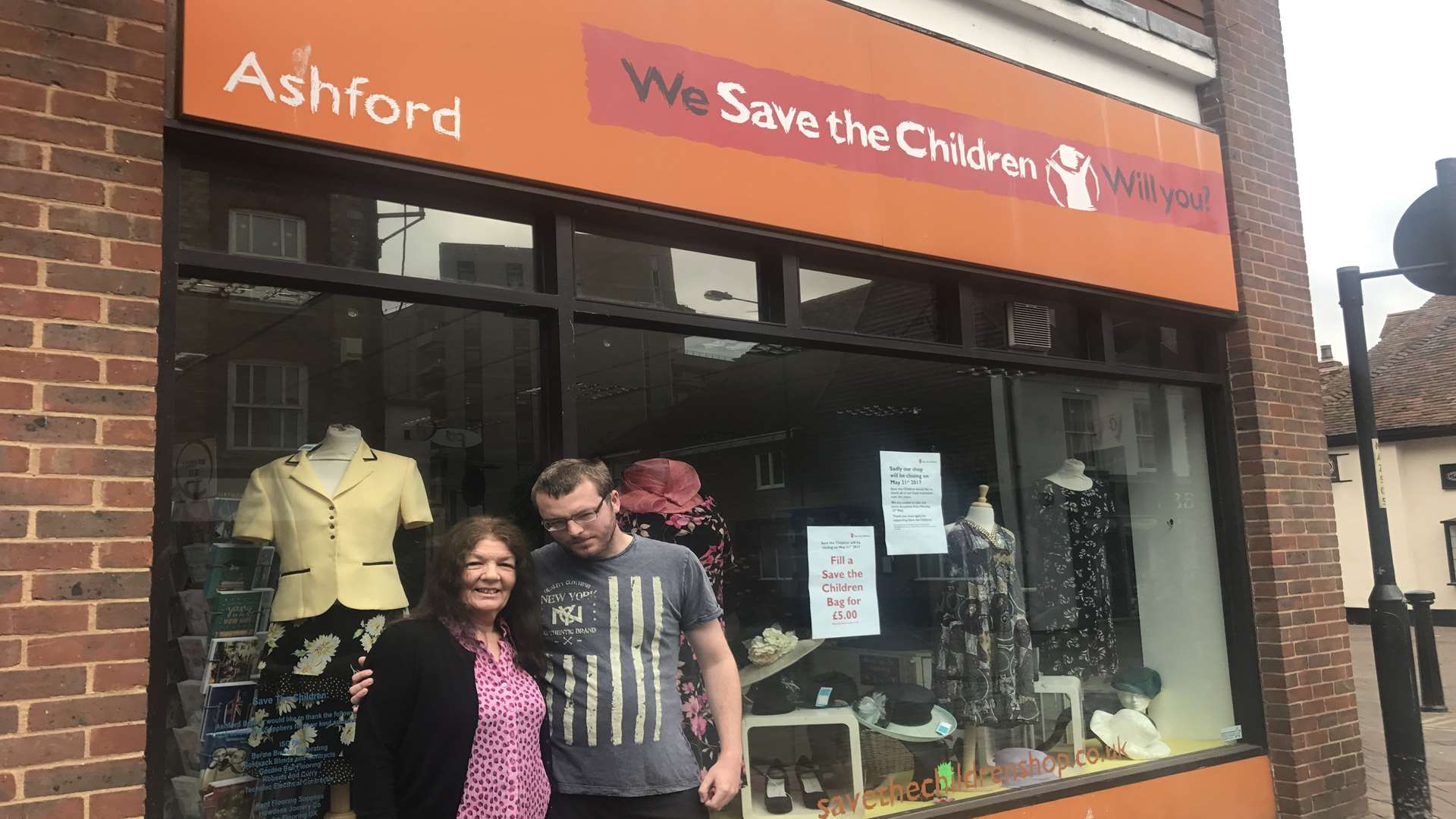 Volunteers Denise Whale and Karl Ruoff outside Ashford's Save the Children branch.