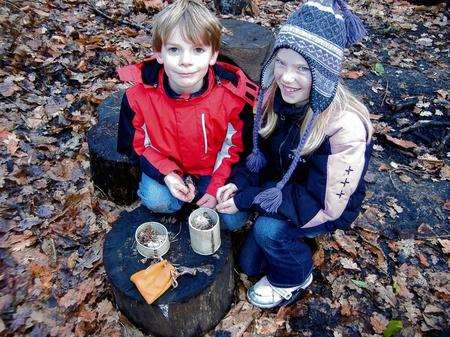 Rebecca and Bryn Scholefield learn survival skills in the woods.