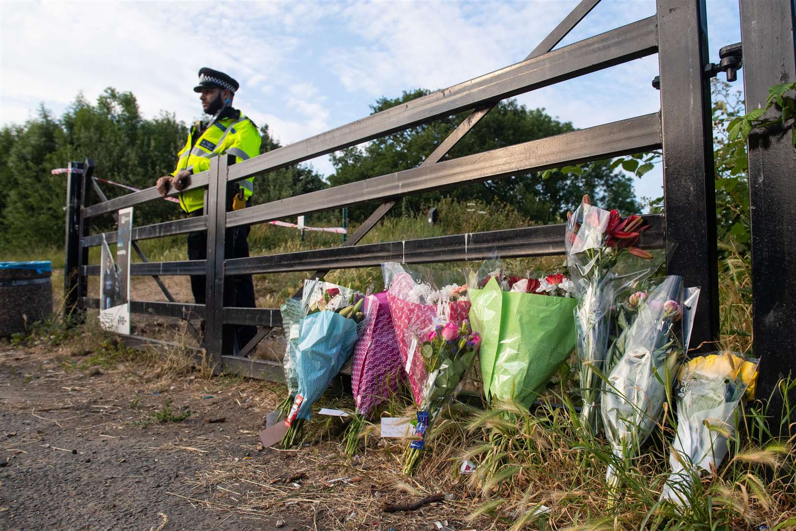 Flowers at an entrance to Fryent Country Park, in Wembley, north-west London, where sisters Bibaa Henry and Nicole Smallman were murdered (Dominic Lipinski/PA)