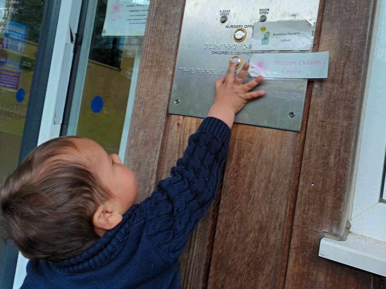 Heidi Taylor's son Rowen reaching up to ring the doorbell of Blossom Children's Centre in Deal