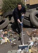 David Cameron helps clear fly-tipping waste. Picture: MATTHEW READING