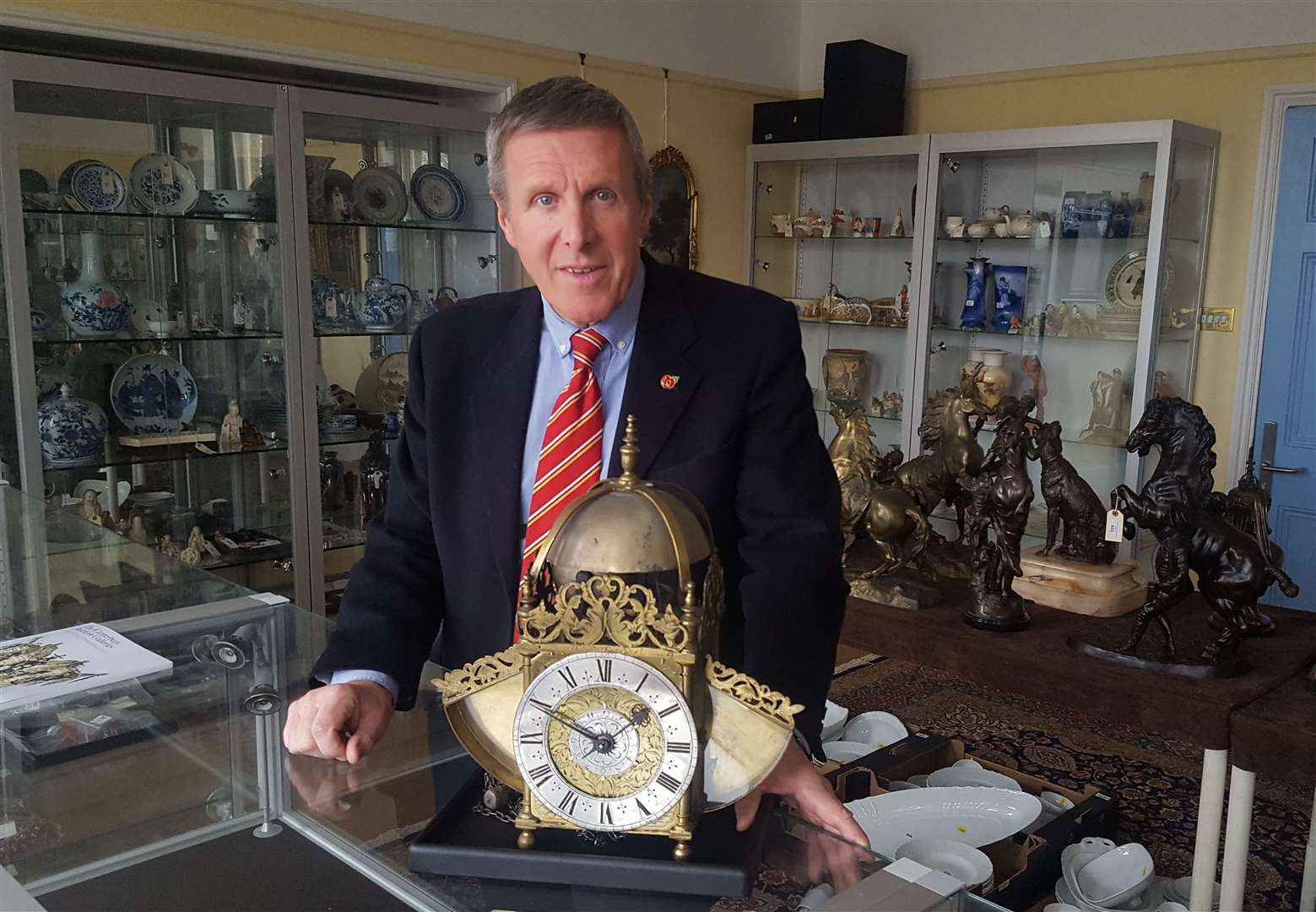 Auctioneer Tony Pratt with a rare Edward East 17th century lantern clock