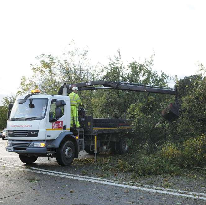 Emergency workers clear a fallen tree blocking the A2 near Ospringe