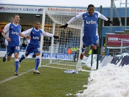 Dennis Oli celebrates his goal by jumping into the snow