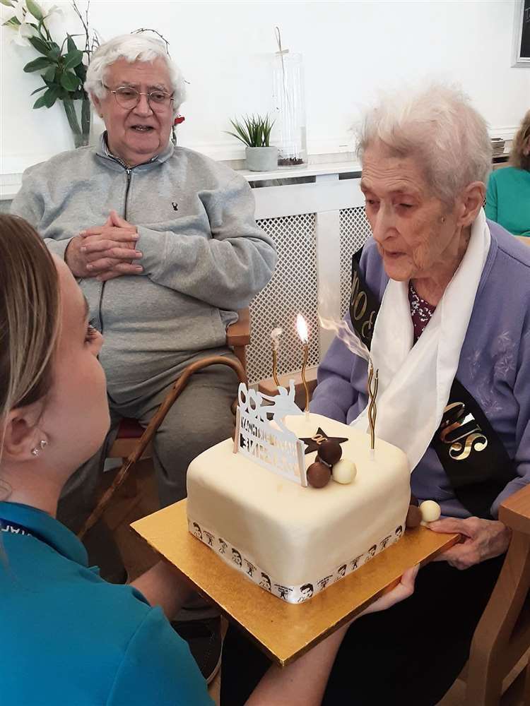 Ms Hikin receives an Elvis-themed chocolate cake (Woodstock Residential Care Centre/PA)