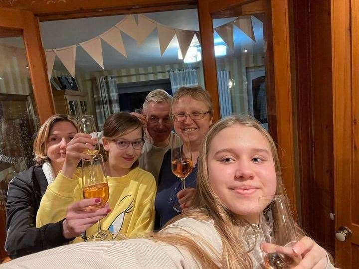 (Left-to right) Ukrainian refugees Irina Kulish and daughter Nastya celebrate their arrival with the Callaghan family, David, Eliza and Olivia