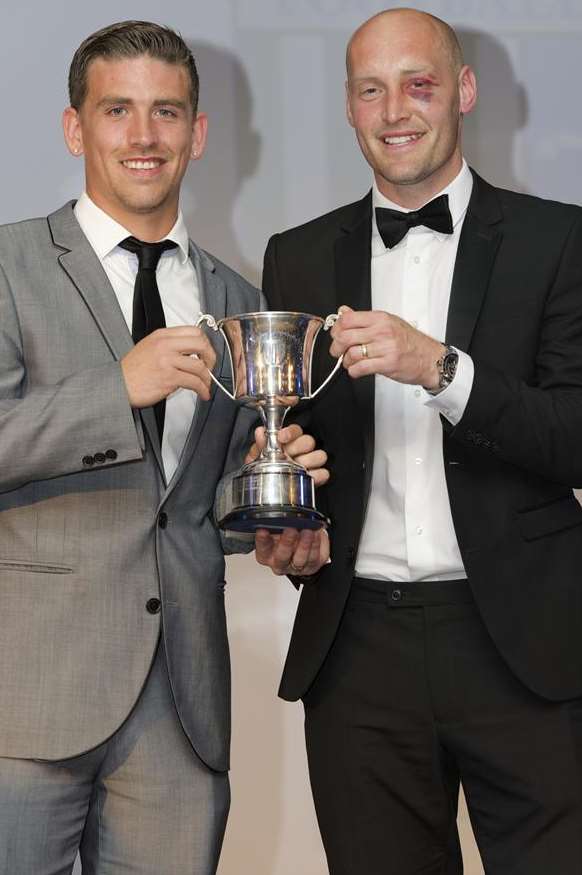 Players' player-of-the-year, Cody McDonald, left, receives his award from club captain Adam Barrett