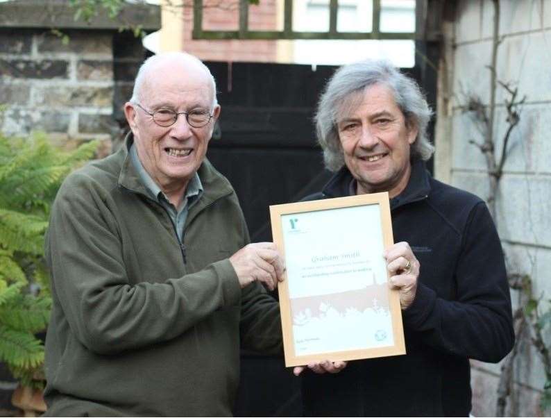 Graham Smith receives his award from former group chairman Ted Roche