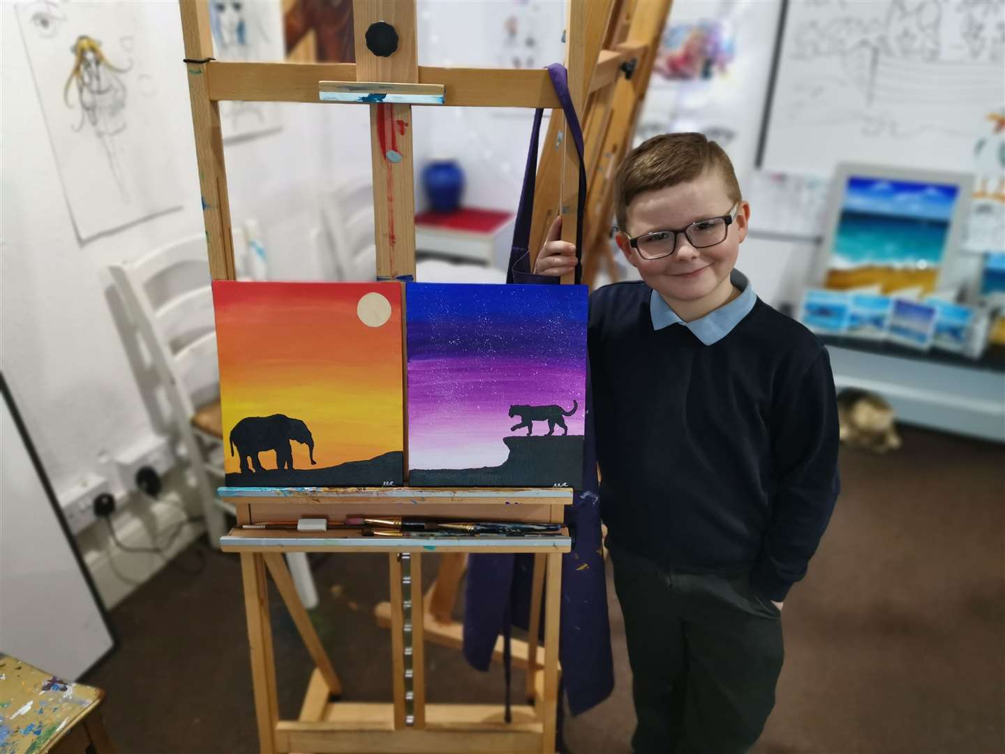Max Coker with his pictures he is selling for charity