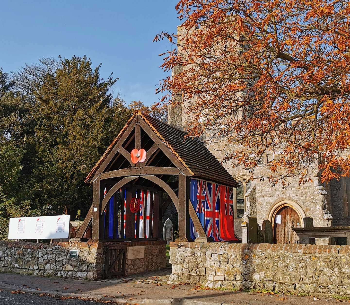 Flags draped over the lychgate at Eastchurch church for Remembrance Sunday. Picture: Mike Francis