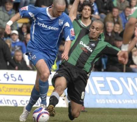 Gillingham's Adam Miller is well tackled by Darren Pratley. Picture: Grant Falvey