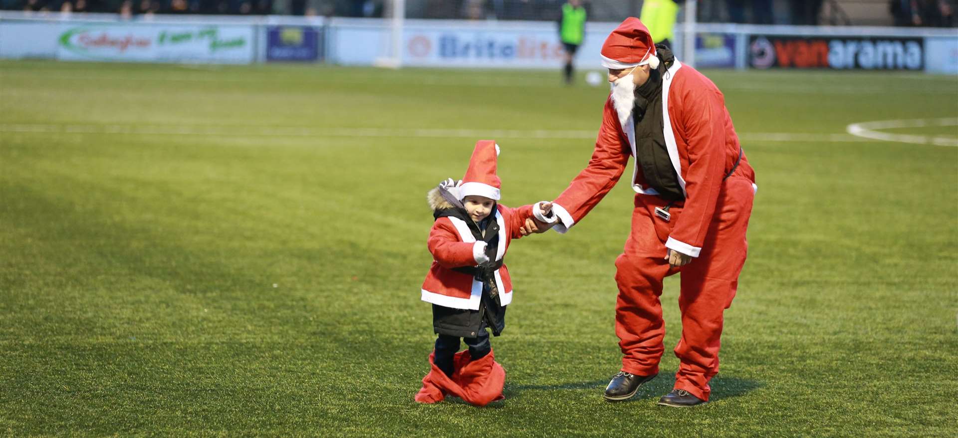 David with son Zak aged four during a Santa Dash to raise money for the Heart of Kent Hospice at Maidstone Football Ground. Picture: John Westhrop.