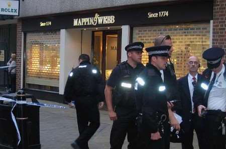 Kent police officers outside the store minutes after the robbery. Picture: ALEX CLARIDGE