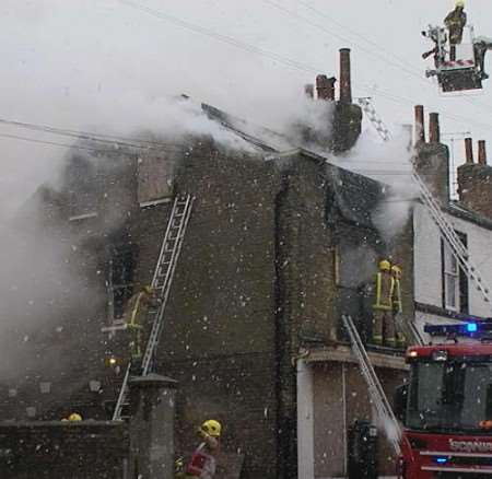 Firefighters tackling the fire at the two-storey building. Picture: Mike Pett
