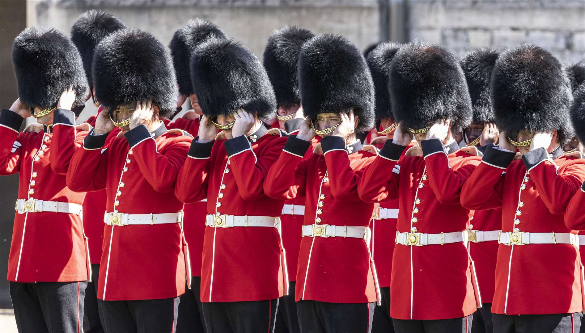 Guardsmen of the 1st battalion Irish guards remove their ceremonial bearskin hats during a parade at Windsor Castle (Richard Pohle/The Times/PA)
