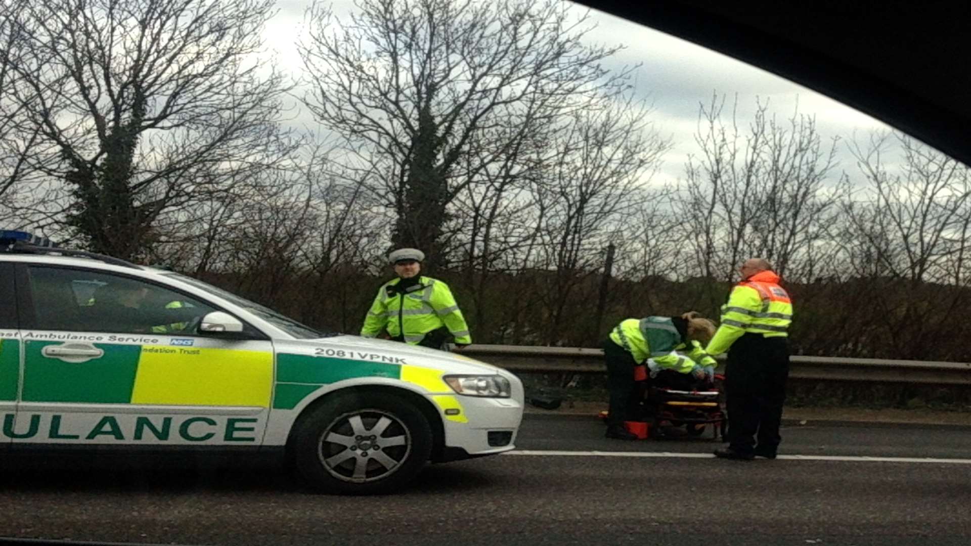 Paramedics treat a casualty as traffic builds up on the M25 due to high winds